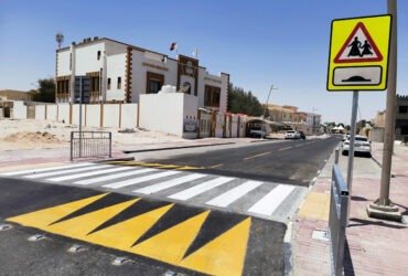 Raised pedestrian crossing with yellow triangle markings in school zone Qatar