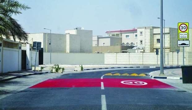 Red speed 30 surface coating and yellow speed humps at school entrance in Qatar